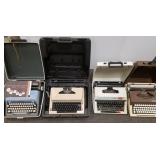 4 vintage typewriters in cases