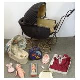 Antique wicker doll buggy with dolls, clothing,
