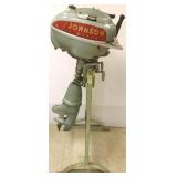 Vintage Johnson outboard motor with stand
