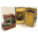 2 toy sewing machines in cases- 1 Singer