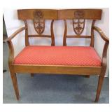 Antique carved loveseat with arms
