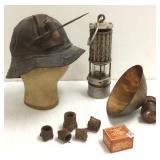 Group including blasting cap, tin, mining lamps,