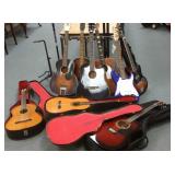 9 assorted electric & acoustic guitars & stands