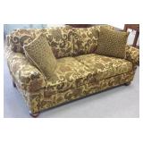Upholstered sofa with pillows
