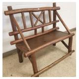 Antique log bench with arms