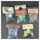 (5) PACKAGES OF MARBLES & SHOOTERS