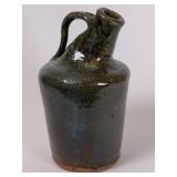 Signed glazed pottery jug