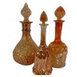 Three Marigold Carnival Glass Decanters