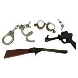 Assortment of Vintage Metal Toy Weapons and Cuffs
