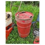 Red Metal Barrel with Tools on Lid