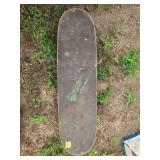 Used Skateboard With Green Flame Graphic