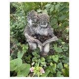 Cement statue boy & girl reading book 15"W x 12"D.