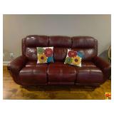 Burgundy Leather Reclining Sofa With Two Accent Pillows