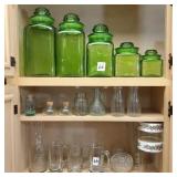 Green cannisters & misc. glassware on 3-shelves