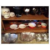 all in lower cabinet: orange cast iron cookware,