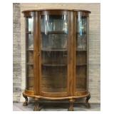 Antique bowfront curio cabinet with lions, claw