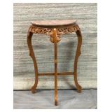 Marble top, half moon table heavily carved