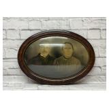 Antique framed portrait with convex glass