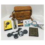 Various camera items. Leather bag, charger,