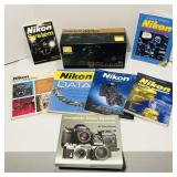 Various Nikon system books. Nikon D3200 box. Box