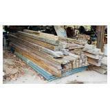Pile of lumber stored under Garage roof