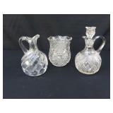 Cut glass cruets and vase
