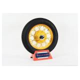 FIRESTONE TIRE WITH SPOKED RIM ON TIRE STAND
