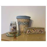 Kleenex box (plastic), wicker waste basket , clear plastic lip stick holders , candle , oval mirror and hand fan
