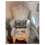 White wicker chair and stool with hand fan and coasters