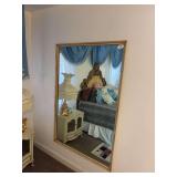 Framed mirror screwed to the wall