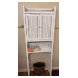 Items in bathroom, wicker stand, trash can, rugs, tp holder, curling irons, miscellaneous