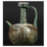 AN EGYPTIAN GLASS HANDLED JUG WITH SIDE SPOUT