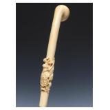 A 19TH C. IVORY CANE HANDLE WITH HERALDIC SHIELD