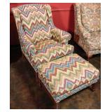 A CHAIR & OTTOMAN IN FLAMESTITCH FABRIC WITH WEAR