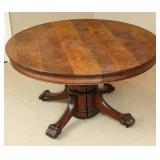 CIRCA 1900 ROUND OAK TABLE WITH LARGE CARVED PAWS