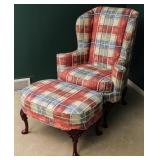 A CUSTOM UPHOLSTERED WINGBACK CHAIR AND OTTOMAN