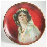 A CIRCA 1905 TIN LITHO PLATE WITH GYPSY GIRL