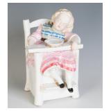 A 19TH C. PORCELAIN TOBACCO JAR, CHILD IN CHAIR