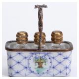 A LIMOGES PORCELAIN BASKET WITH MINIATURE PERFUMES