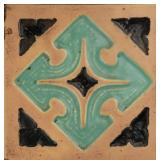 A CARVED AND GLAZED TERRA COTTA ARCHITECTURAL TILE