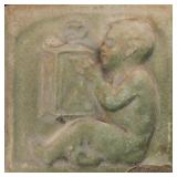 A GREEN MATTE TERRA COTTA RELIEF TILE CIRCA 1890