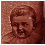 A 19TH C. GLAZED TILE WITH A PORTRAIT OF A CHILD