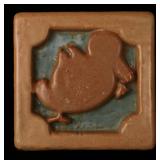 A DEEPLY CARVED TERRA COTTA ARCHITECTURAL TILE