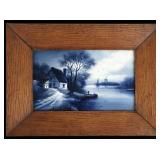 AN EARLY 20TH CENTURY DELFT PLAQUE IN OAK FRAME