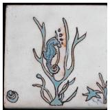 A GLAZED TERRA COTTA TILE WITH SEAHORSE & AQUATICS