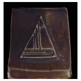 AN EARLY 20TH C. ART TILE WITH CARVED SAILBOAT