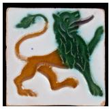 AN ANTIQUE ART POTTERY TILE WITH LION