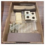 Assorted coin supplies including coin flips, acryl