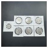 Seven Kennedy half dollars from the 1970s and onel
