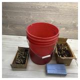 Five-gallon bucket full of reloading brass in vari